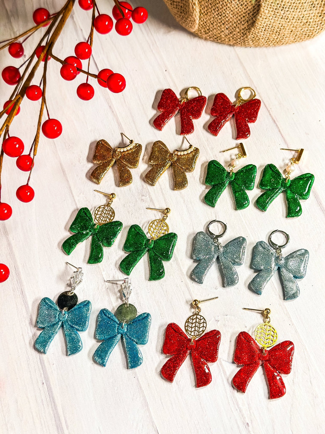 The Dappled Wood Ho Ho Bow earrings collection in Santa Red, Fir Green, Gold, Silver, and Frost Blue. A handcrafted polymer clay earring set with festive shimmer, perfect for holiday gifting and celebrations.