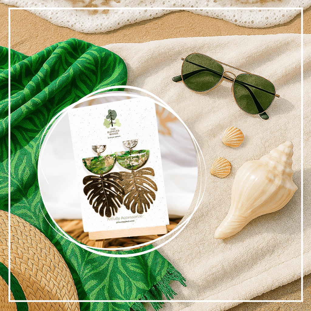 The Dappled Wood's Isolde green and gold statement earrings from the Gilded Grove Collection, styled for a beach day with summer accessories.