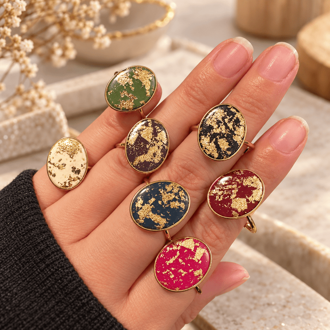 Seven colorful Gemma faux-stone adjustable rings displayed on a hand at The Dappled Wood.