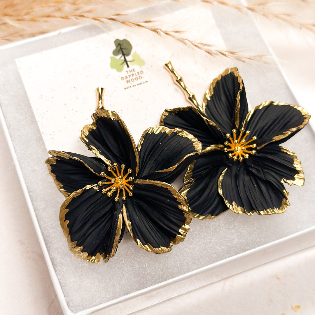 Handcrafted black floral polymer clay earrings with gold accents from The Dappled Wood's Floral Earrings Collection.