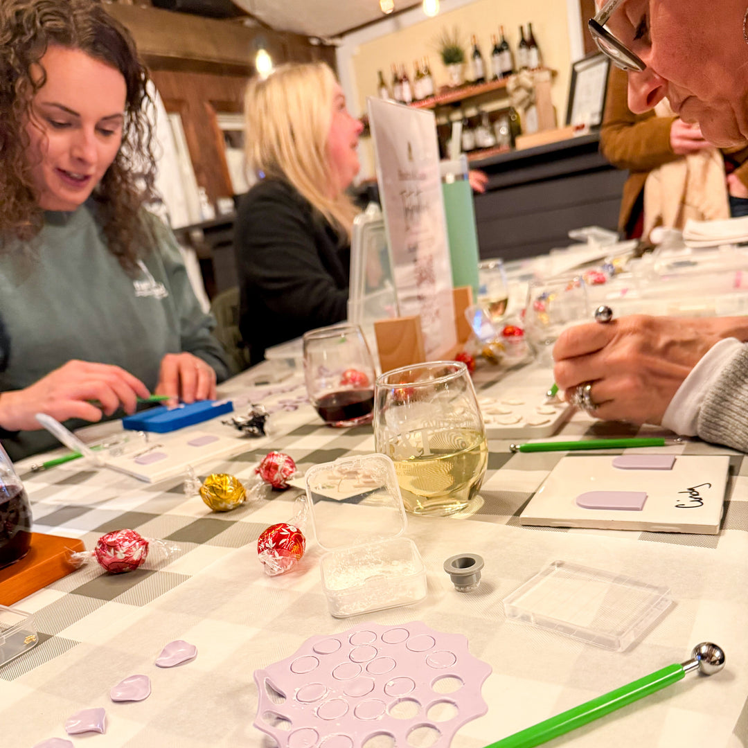 Workshop participants seated at a table using various crafting tools while working on creative projects at a The Dappled Wood event.