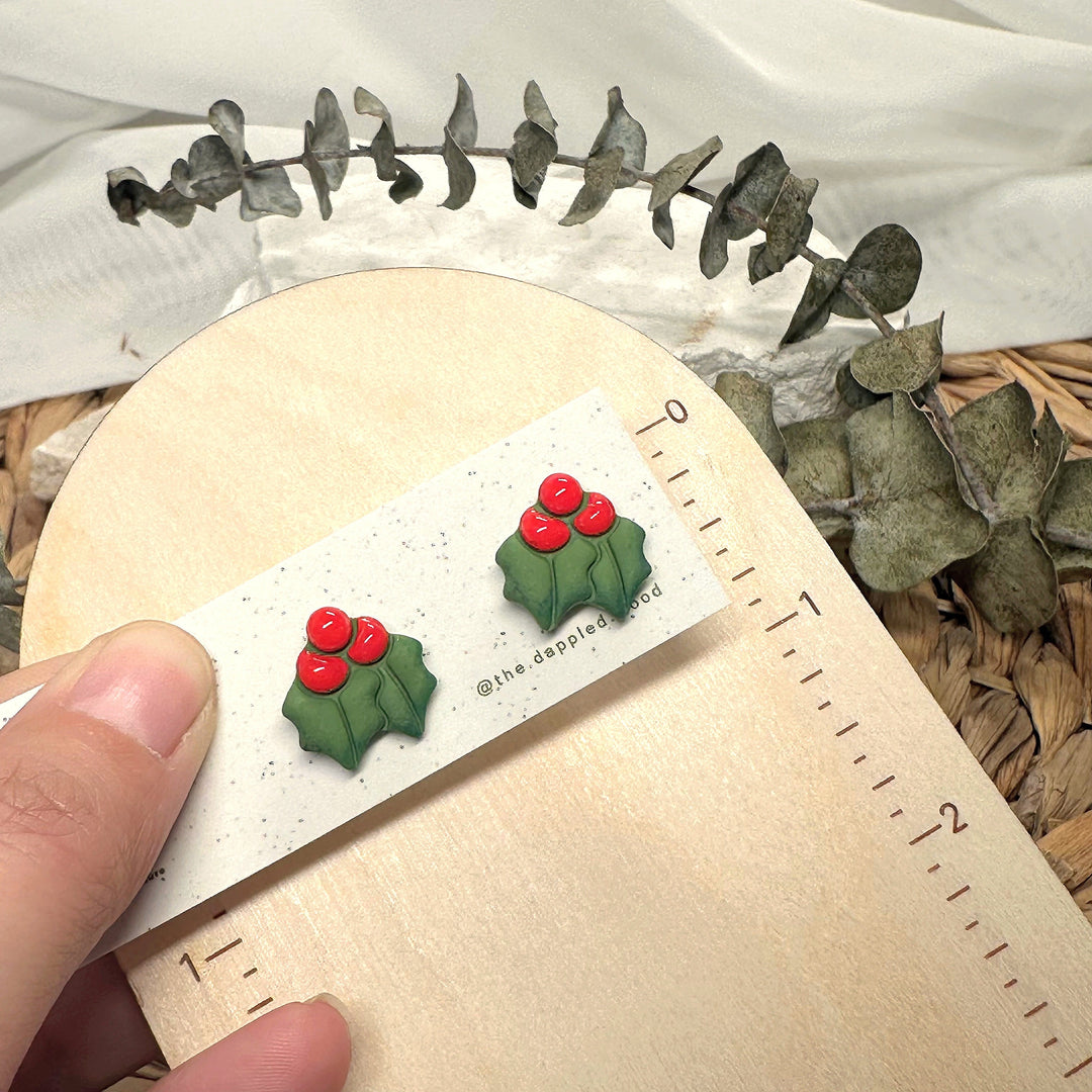 Agnes stud earrings beside a ruler showing size and scale