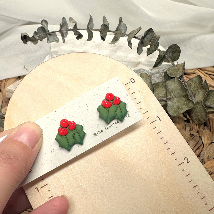 Agnes stud earrings beside a ruler showing size and scale