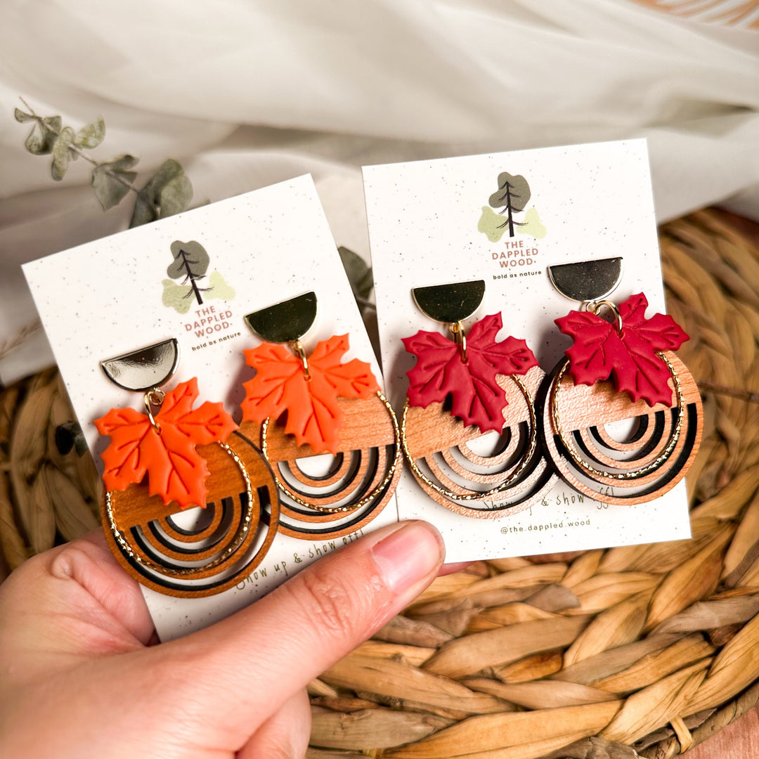 Arden maple leaf and wood earrings shown in burnt orange and brick red