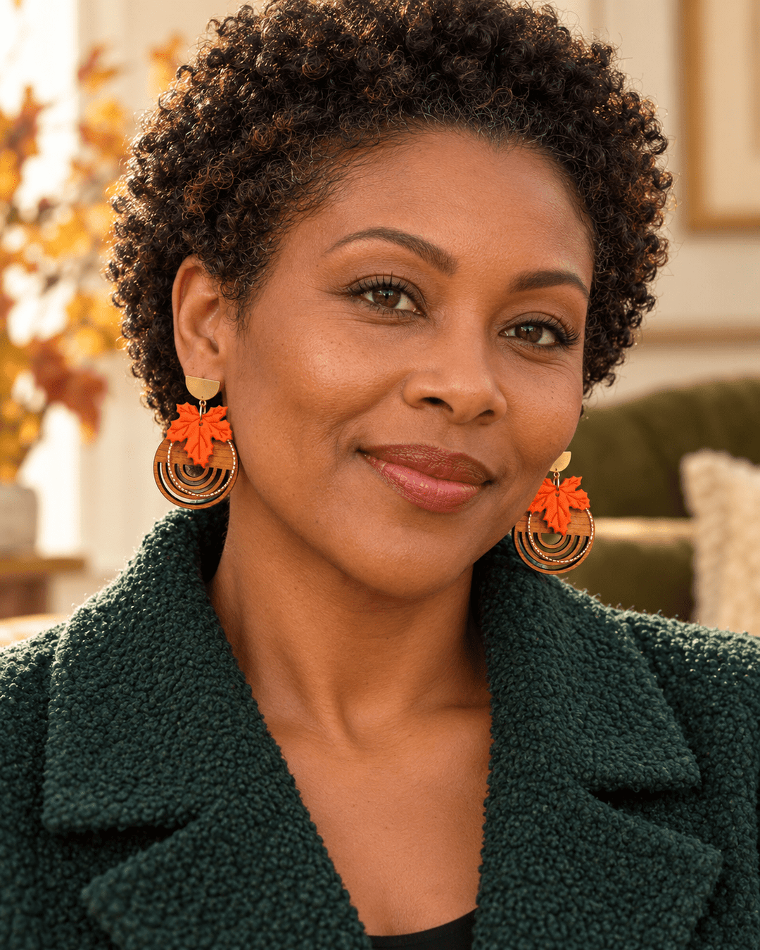 Model wearing a pair of Arden maple leaf and real wood statement earrings