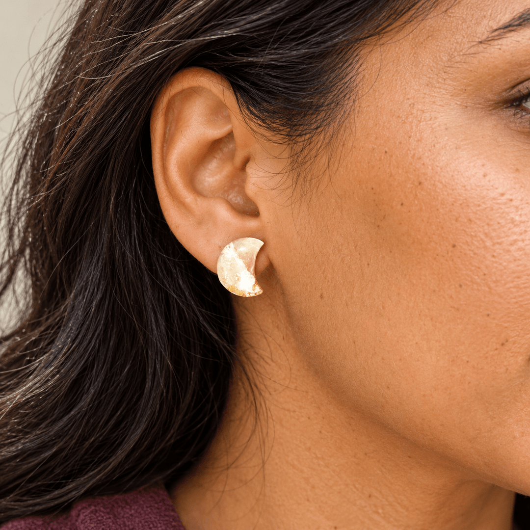 Model wearing Aylin mini crescent moon studs in creamy Ivory Coast faux stone with gold flecks