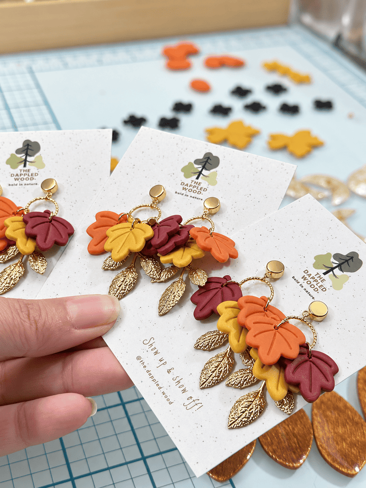 Fallon Autumn Leaf Earrings by The Dappled Wood in burgundy, mustard yellow, burnt orange, and textured gold.