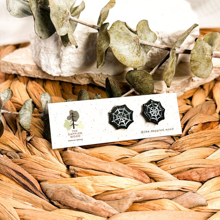 Black and white spiderweb Halloween stud earrings with hand-painted details