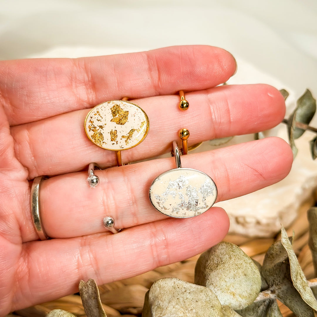 Ivory Gemma faux stone rings shown with gold-plated and silver stainless steel adjustable bands.
