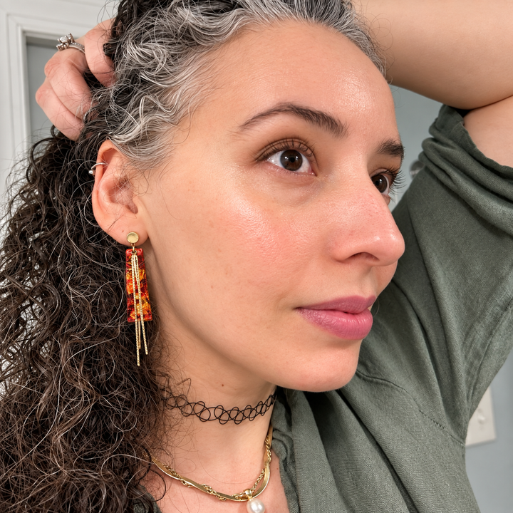 Model wearing Marisol faux Mexican fire opal tassel earrings by The Dappled Wood.
