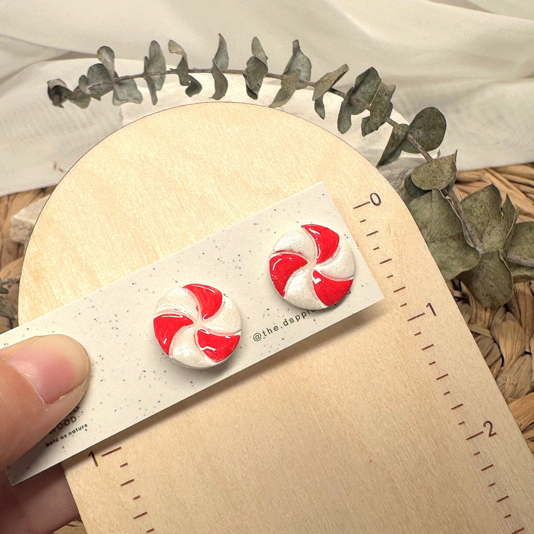 Merryn stud earrings beside a ruler showing size and scale