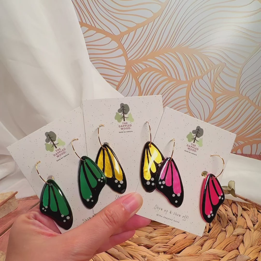 Winged Whispers faux butterfly wing earrings shown in motion.