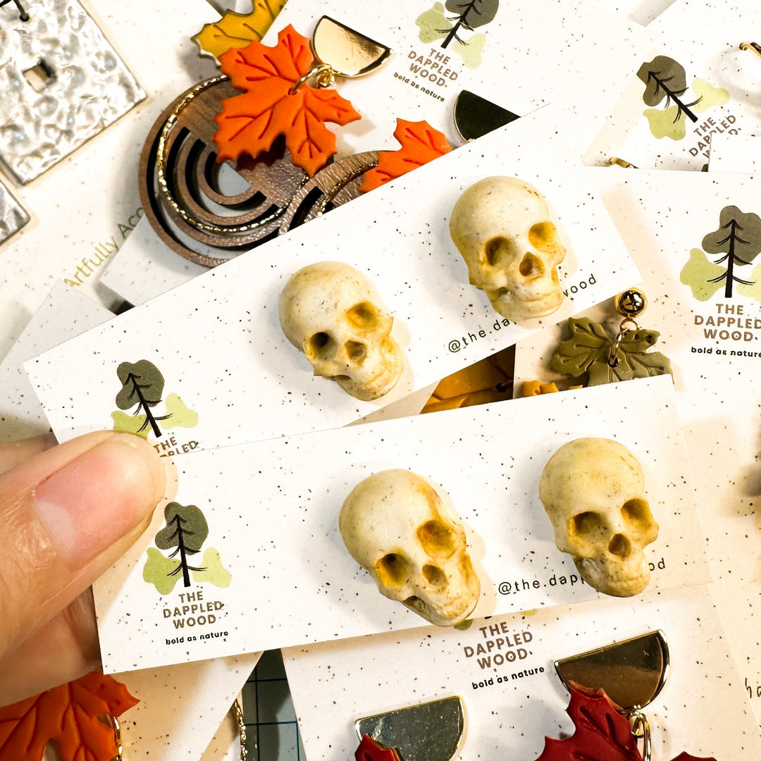 Sybil sculpted skull stud earrings in ivory handmade polymer clay