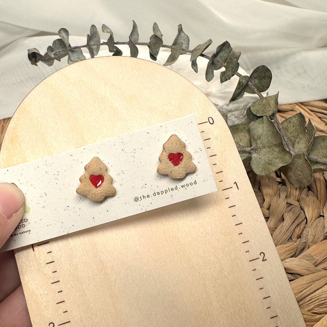 Colette Christmas tree cookie stud earrings shown beside measuring tape for scale