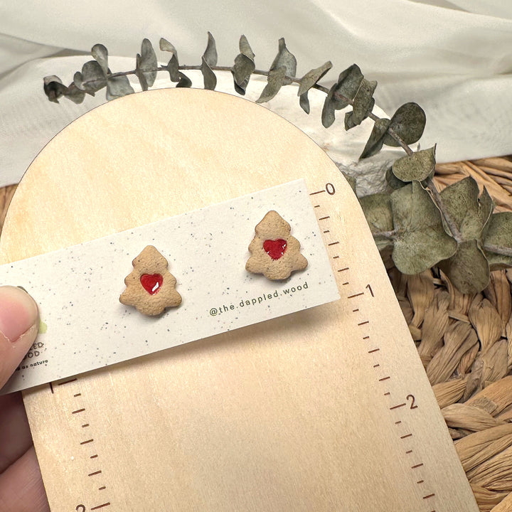 Colette Christmas tree cookie stud earrings shown beside measuring tape for scale