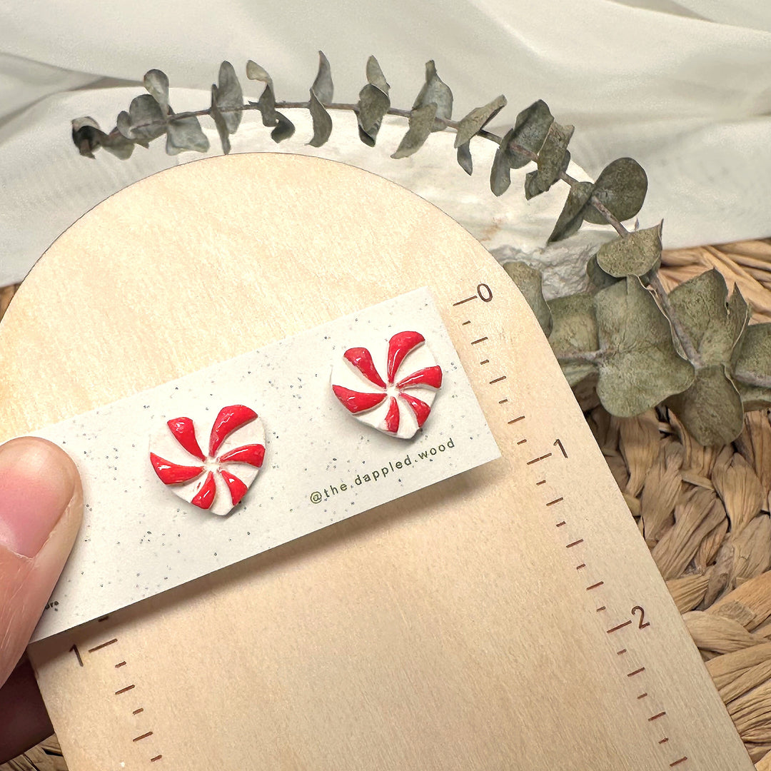 Merryn peppermint stud earrings photographed beside measuring tape for scale