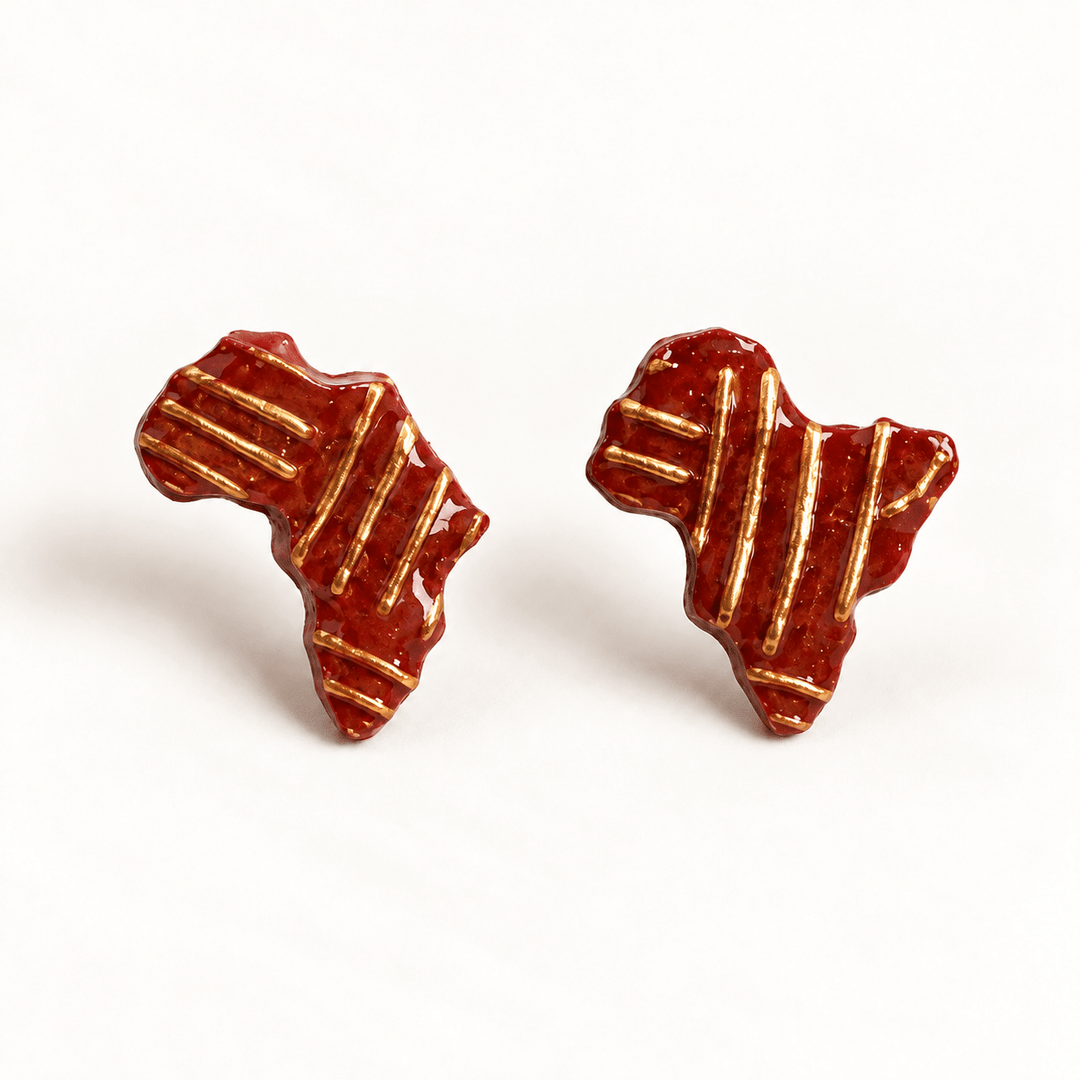 Ayana brick-red Africa stud earrings with raised gold patterns, both oriented upright on white.