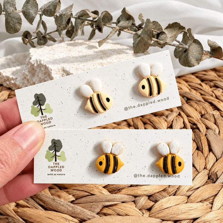 Handmade Beatrix bee studs in two yellow colorways on The Dappled Wood display cards
