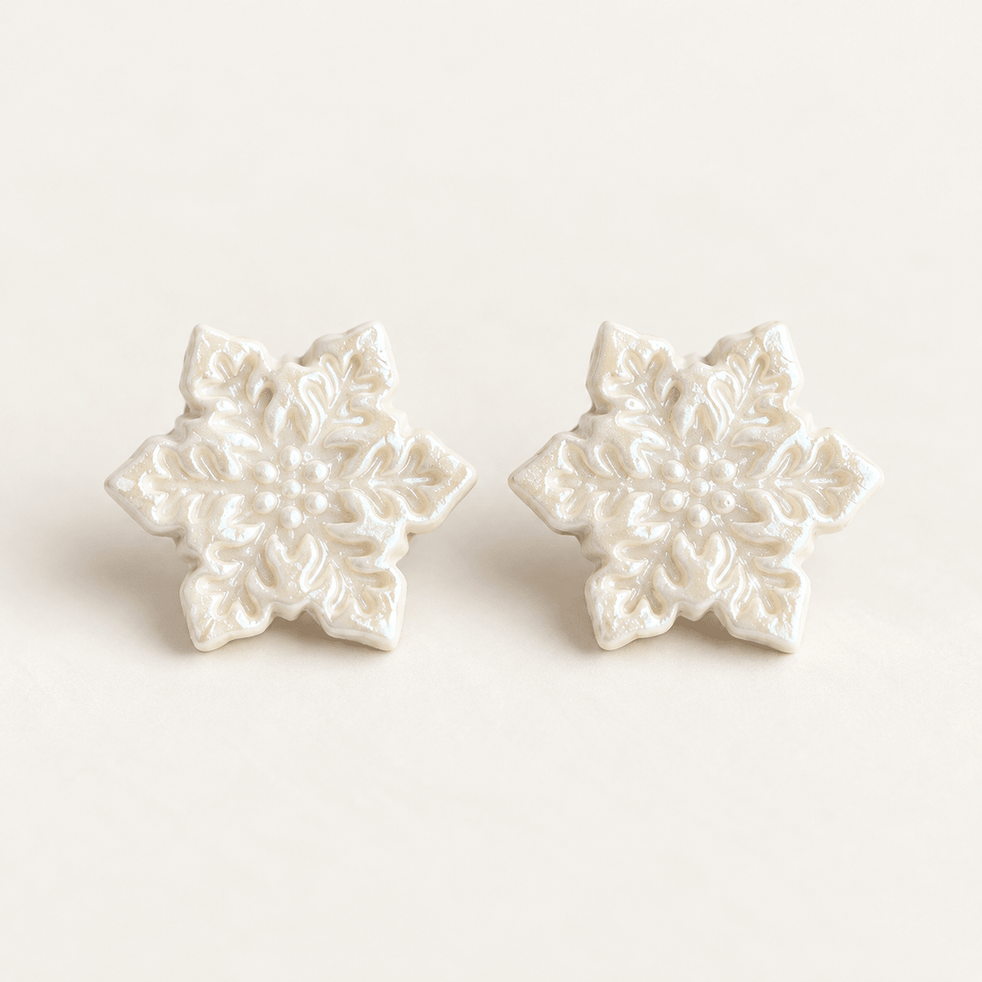 Blanche white snowflake stud earrings with embossed detail and a pearly finish