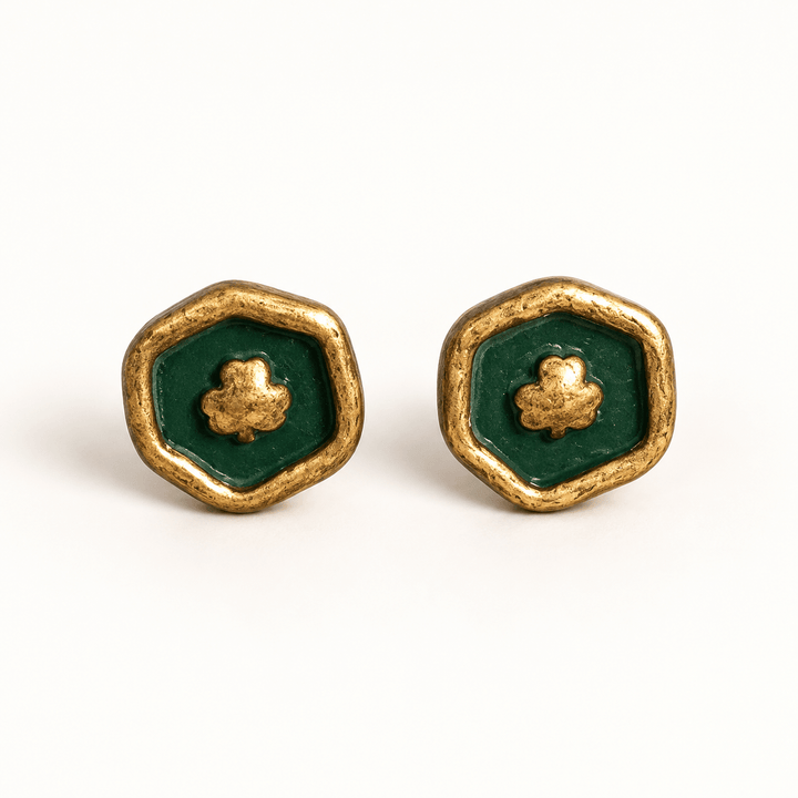 Felicity handmade green clover stamp stud earrings with gold rims on white.
