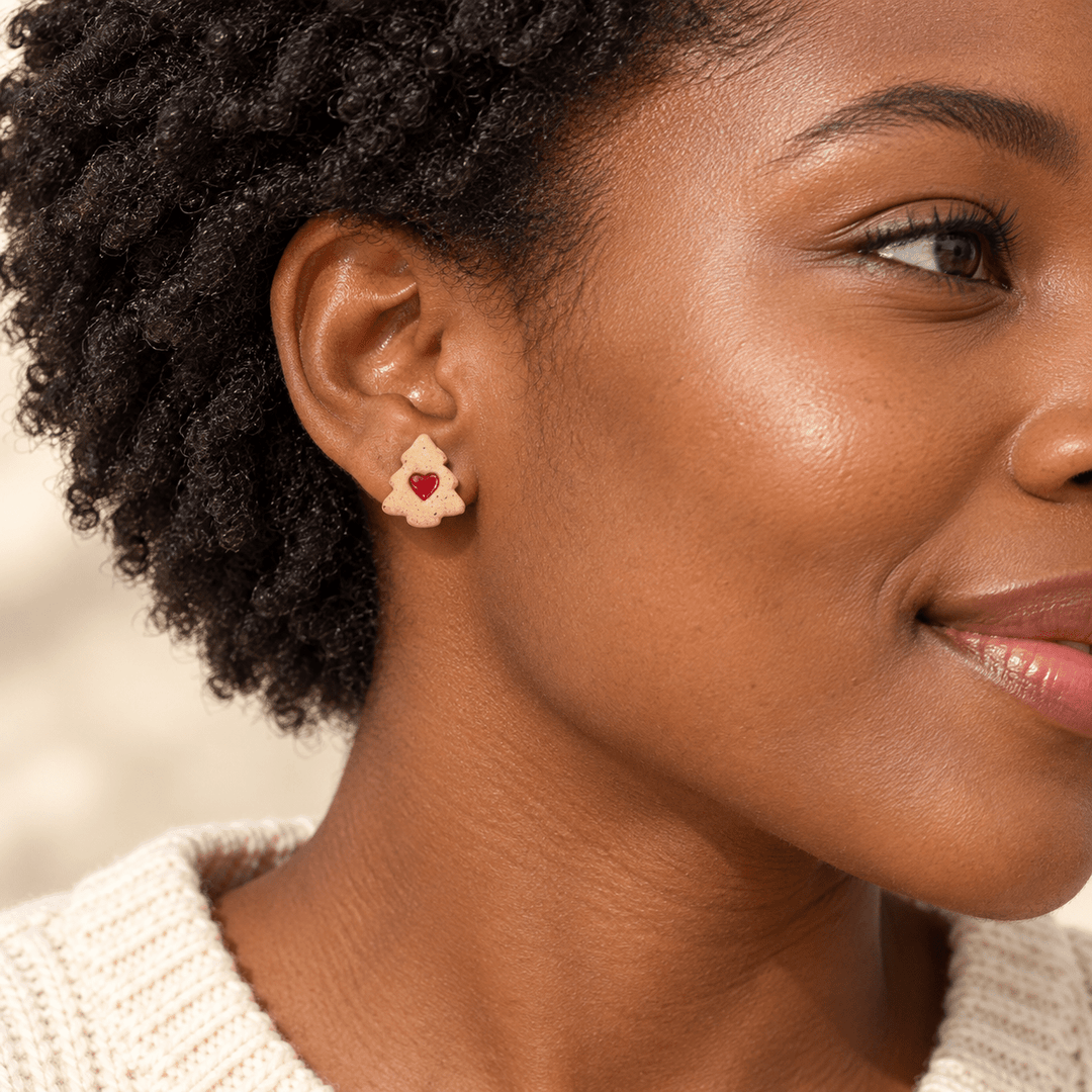 AI-generated styling preview of a model with a short natural afro wearing a Colette tree cookie stud; scale is illustrative