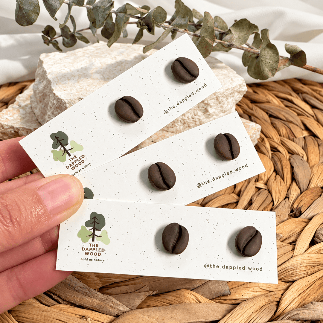 Three pairs of Demi coffee bean studs on The Dappled Wood display cards