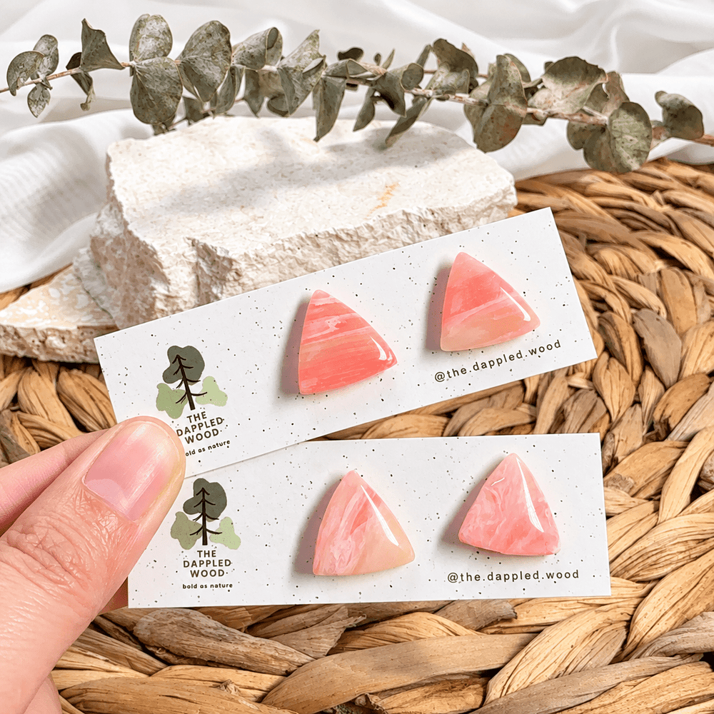 Two pairs of handmade Elodie pink marbled triangle studs on display cards