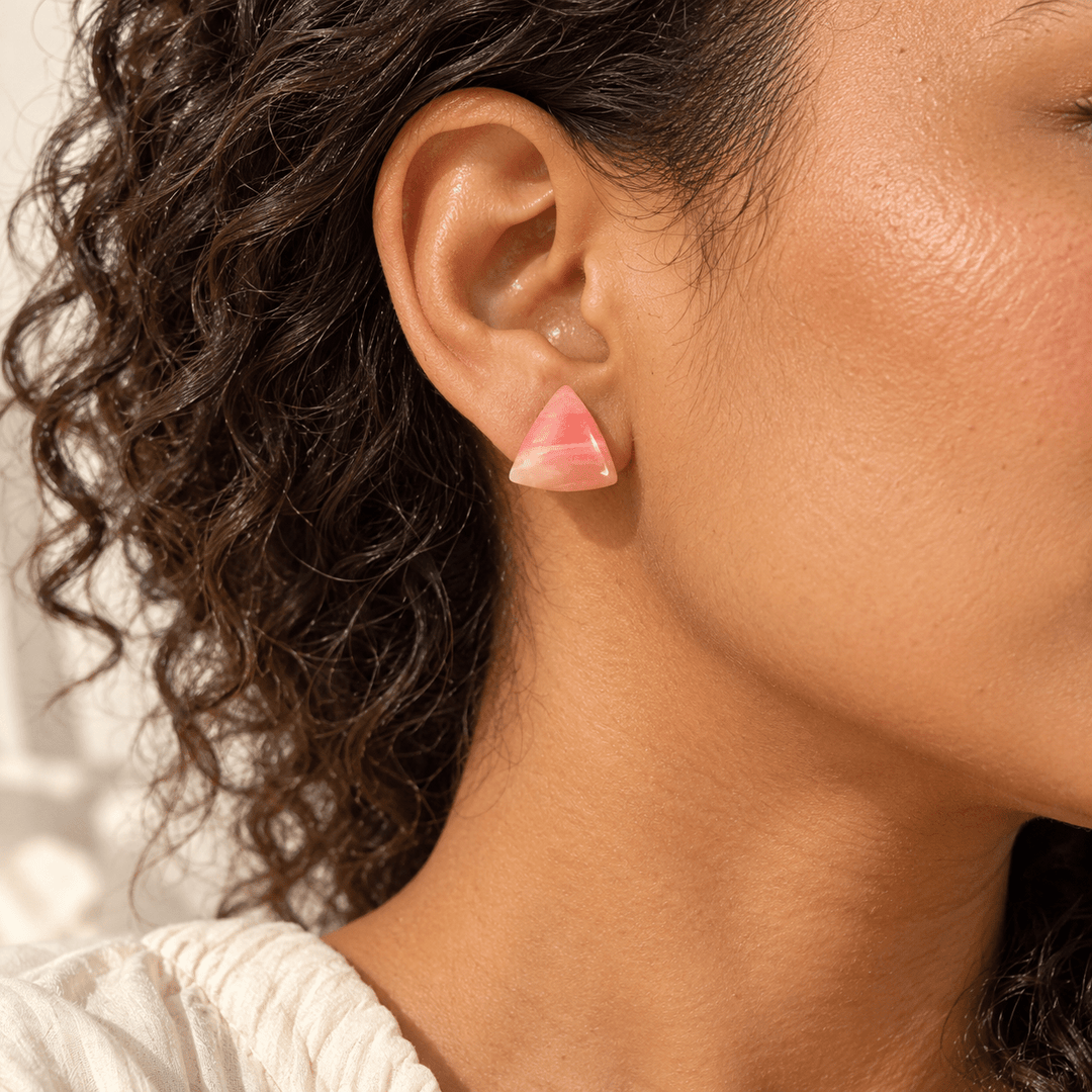 AI-generated styling preview of Elodie faux rose quartz triangle studs; scale is illustrative