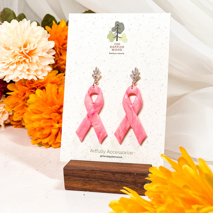 Gold art deco post earrings featuring a pink ribbon design, crafted for The Dappled Wood’s breast cancer awareness collection.