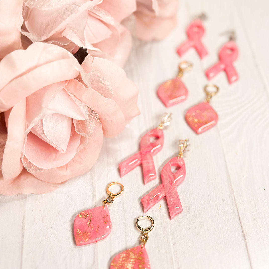 Group image of The Dappled Wood’s Katherine Pink Ribbon Earrings collection, featuring handcrafted polymer clay earrings in various designs for breast cancer awareness.