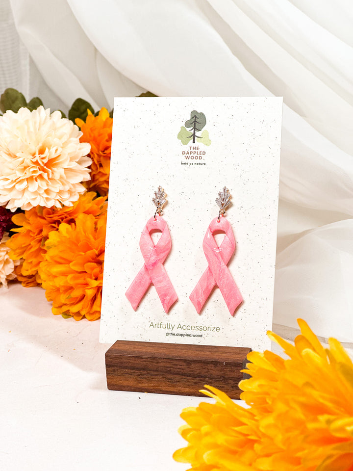 Silver art deco post earrings featuring a pink ribbon design, part of The Dappled Wood’s Pinktober collection for breast cancer awareness.