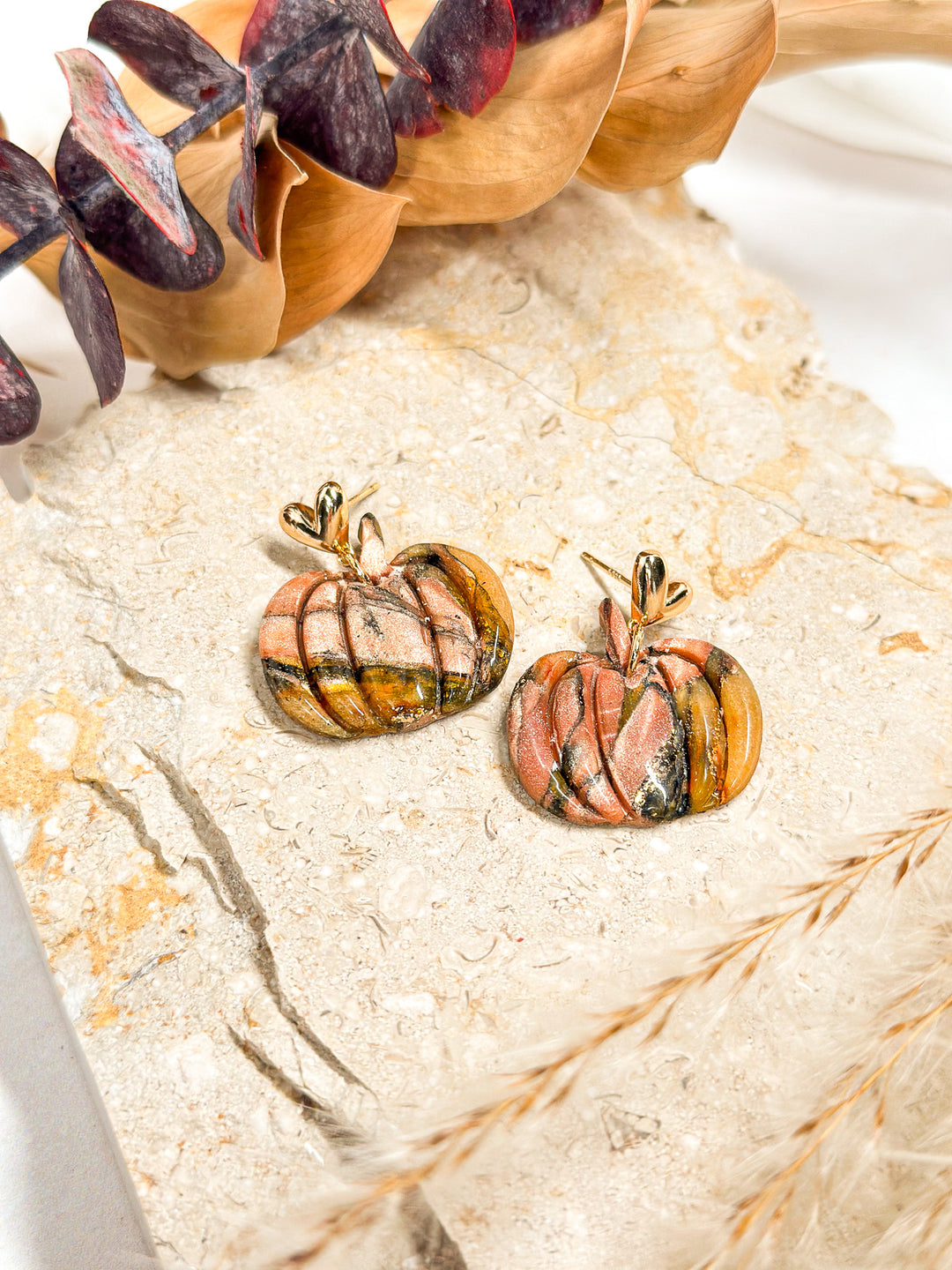 Small pumpkin earrings with 3D gold heart posts from the Fallen Leaves collection by The Dappled Wood. A festive and nature-inspired fall accessory.