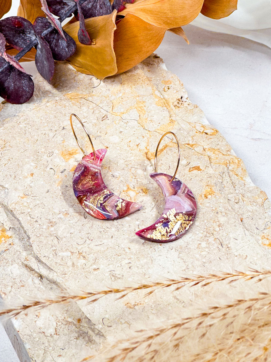 Crescent moon earrings from Veins of Violet, featuring faux purple agate, 18k gold-filled hoops, and celestial-inspired design. Handmade, lightweight, and hypoallergenic.