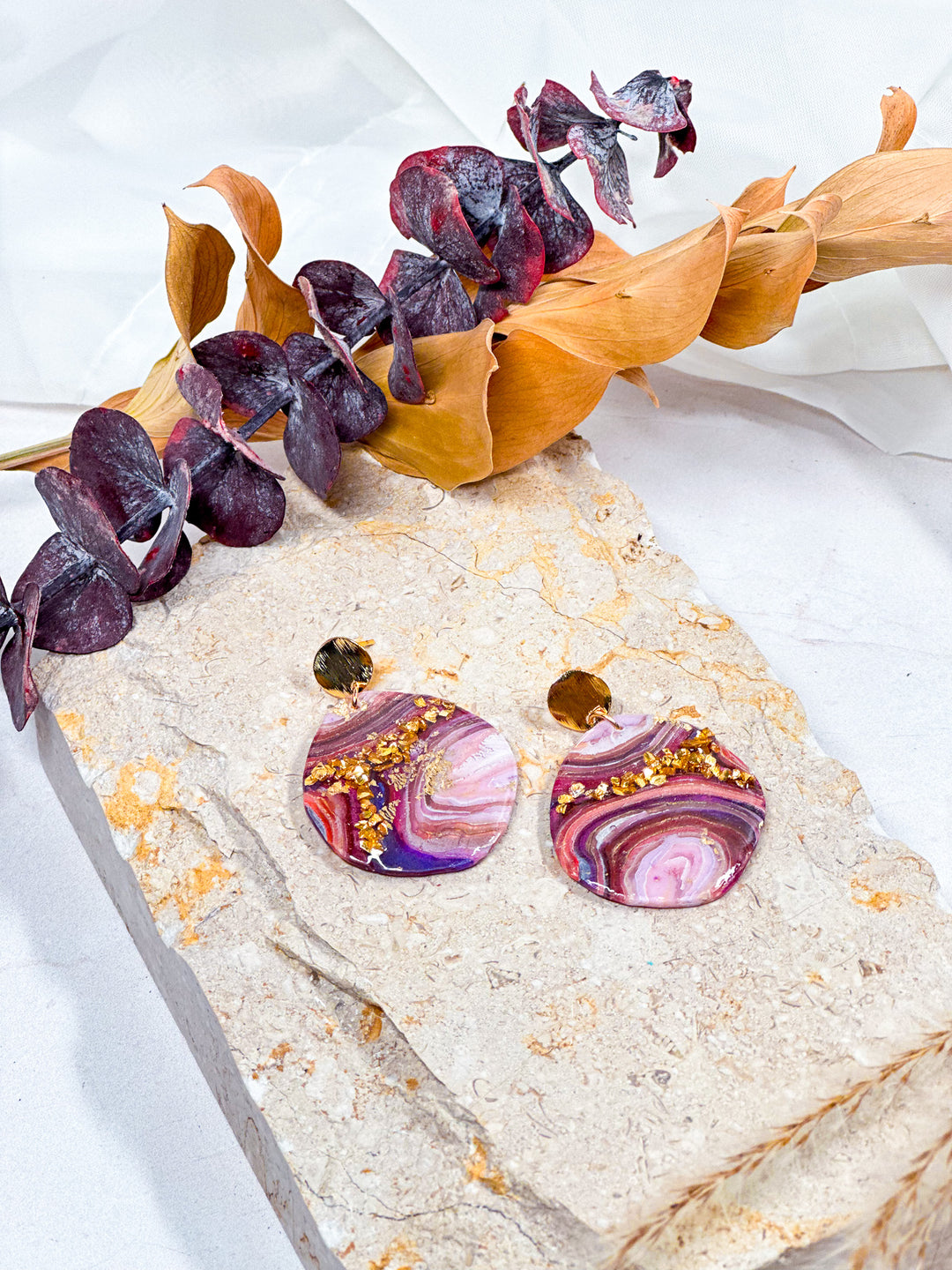 Organic circle earrings from Veins of Violet, featuring faux purple agate with gold glitter veins, and brushed gold circle posts. Elegant, lightweight polymer clay jewelry.