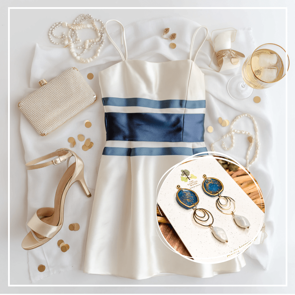 The Dappled Wood’s Rhea navy blue and faux baroque pearl statement earrings, shown with a cream and navy cocktail dress, pearl accessories, and champagne for an elegant holiday party look, Fall 2025