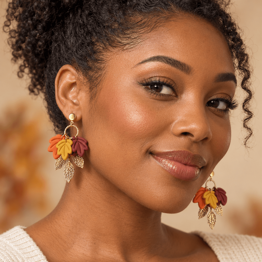 Woman wearing Fallon autumn leaf earrings in burgundy, mustard, orange, and gold.