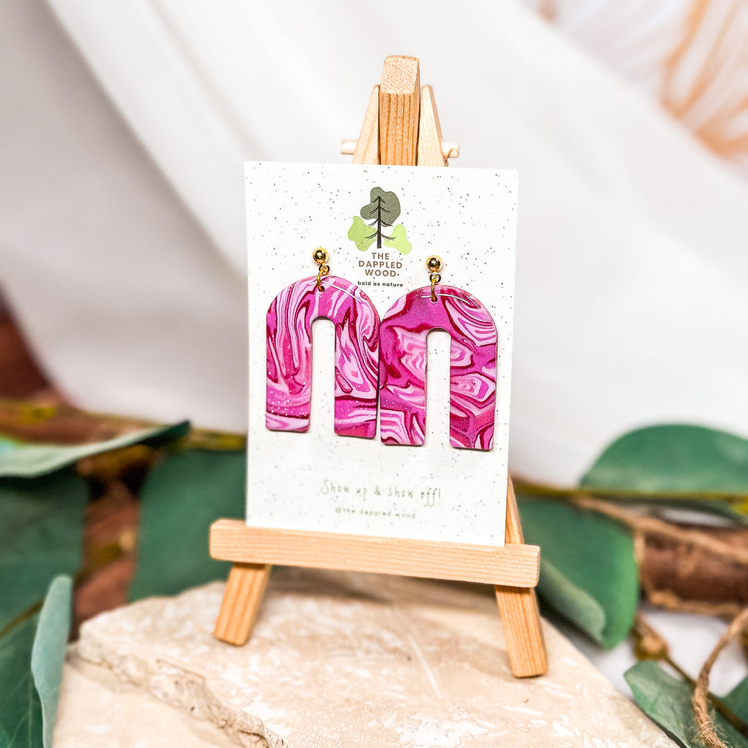 The Dappled Wood Hot Pink Mokume Gane polymer clay earrings from the Cupid's Cache collection in February 2024, featuring 18k gold-filled ball posts.