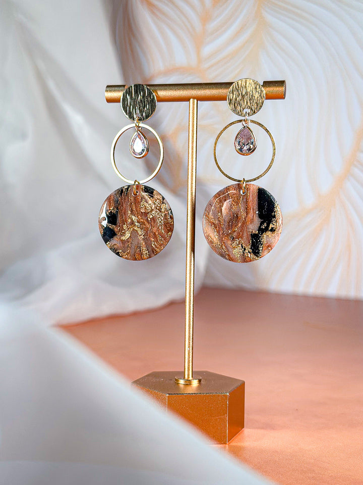 The Dappled Wood Molten Mirage solid circle earrings with a gold hoop and gemstone, elegant marbled bronze jewelry.