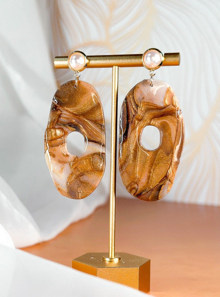 The Dappled Wood Molten Mirage XL long donut earrings with faux pearl post, nature-inspired statement earrings.