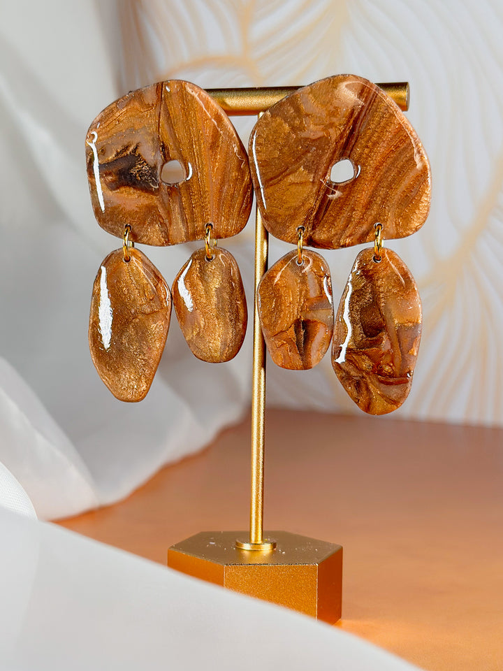 The Dappled Wood Molten Mirage XXL organic donut earrings with chunky dangles, bold and artistic marbled bronze jewelry.