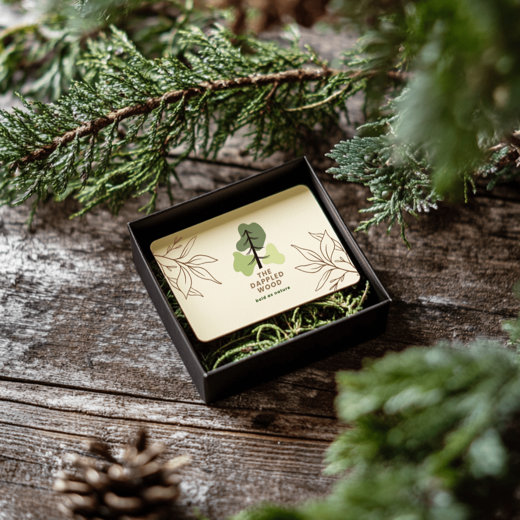 The Dappled Wood gift card displayed in a black box with natural moss.