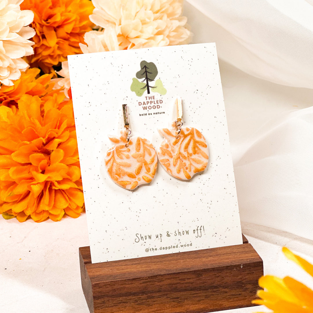 Gold embossed apple earrings, autumn-inspired lightweight statement jewelry by The Dappled Wood.