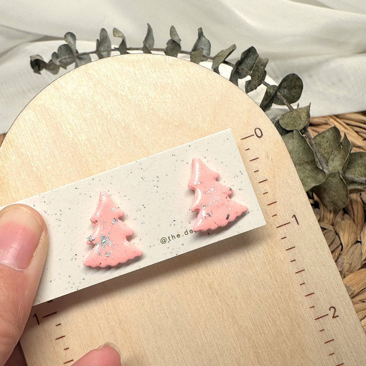 Juniper stud earrings beside a ruler showing size and scale