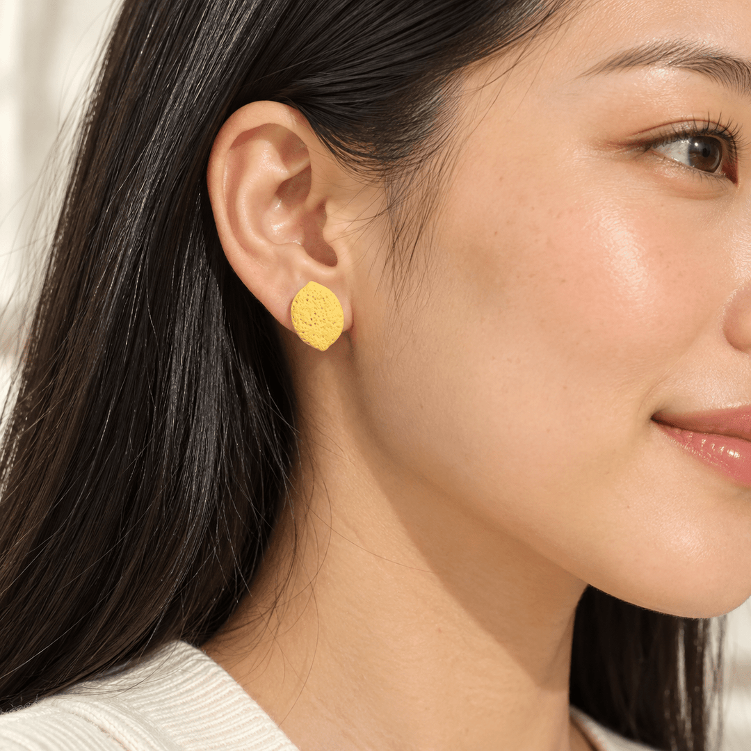 AI-generated styling preview of a model with straight black hair wearing a Leni lemon stud; scale is illustrative