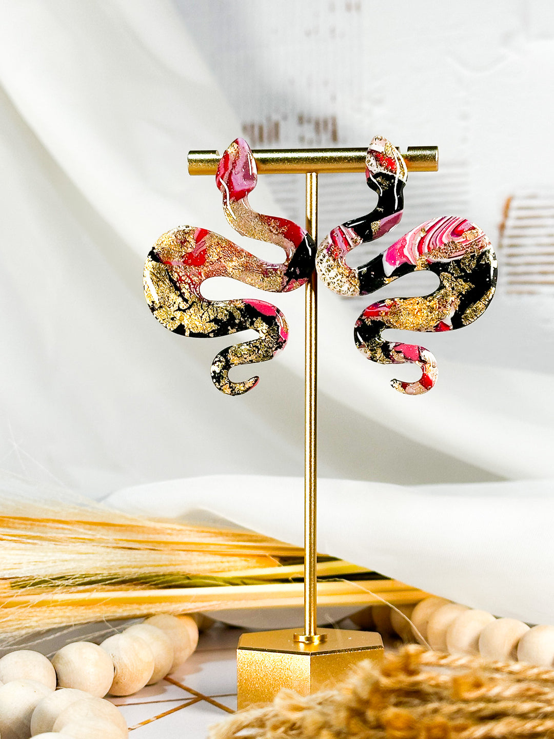 The Dappled Wood Lilith Collection snake earrings in Punk Princess. A striking mix of black, pink, and gold, combining edgy and elegant design in hypoallergenic statement earrings.