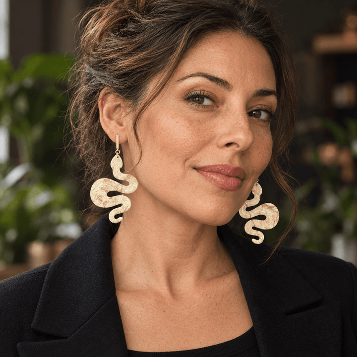 Model wearing oversized Lilith Ivory Coast faux-stone polymer clay snake statement earrings by The Dappled Wood.