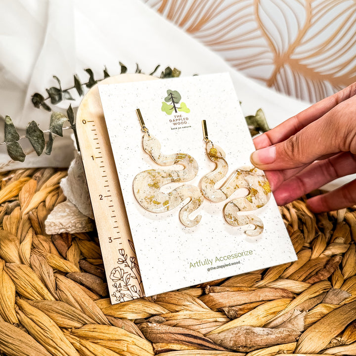 Lilith Ivory Coast faux-stone snake statement earrings shown beside an inch ruler, measuring approximately 3 inches long.