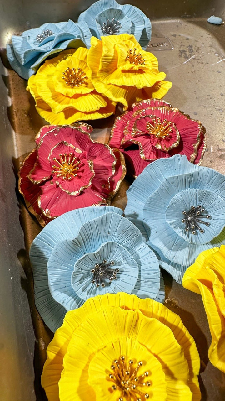 Luisa circular floral statement studs in baby blue, bright yellow, and pink.