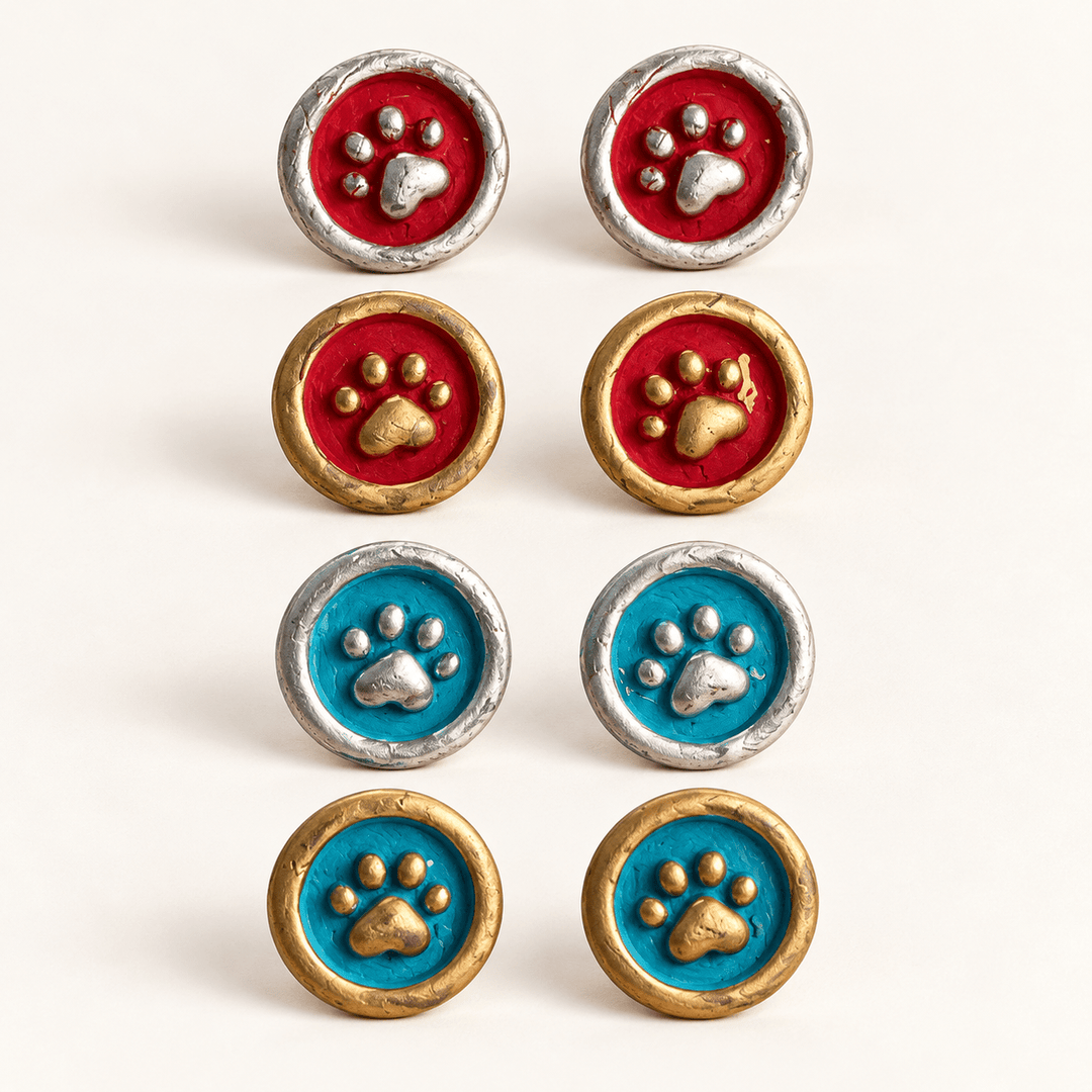 Maisie paw-print stamp studs in all four red, teal, gold and silver combinations.