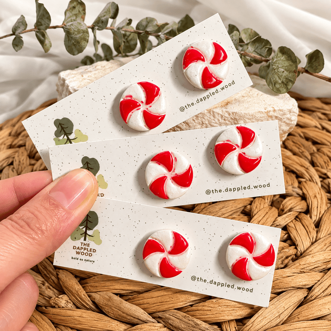 Merryn round red and pearly white peppermint stud earrings on display cards.